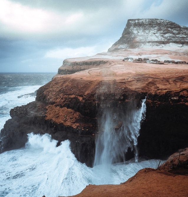 waves crash on a cliff